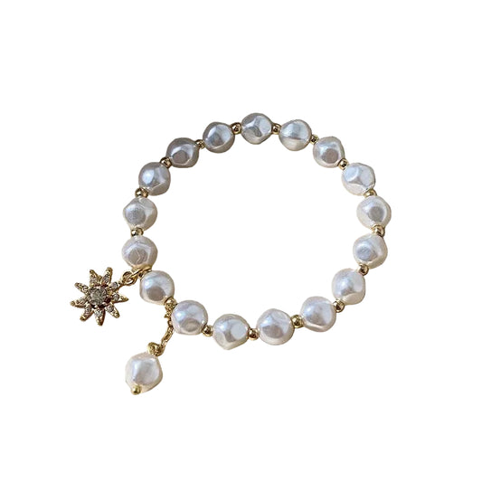 Pulsera con colgante en oro blanco, perla y girasol