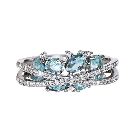 Anillo con cruz en plata y piedra preciosa azul